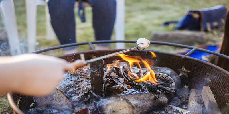 hand grilling food at corporate summer bbq party