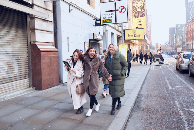 three women having fun taking part in winter team building activities with connectin events