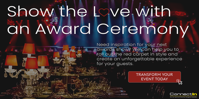 tables with ornamental lights with awards ceremony in the background