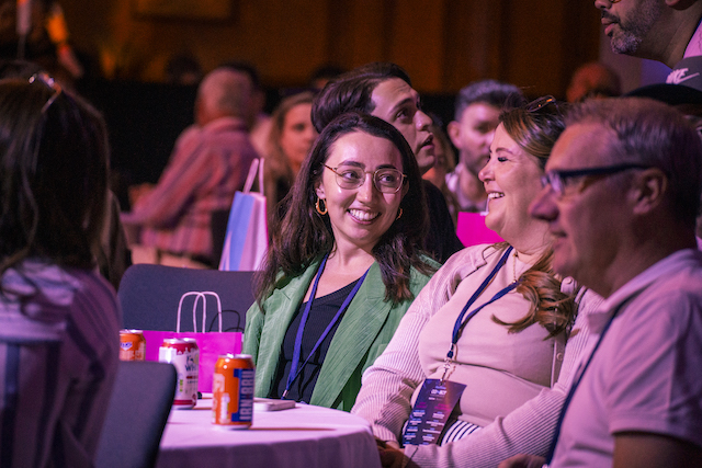 smiling woman at connectin events blue arrow conference. The experts at knowing how to plan a conference.